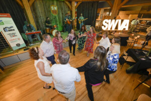 Group dances in a circle to a band at the Southwest Virginia Cultural Center & Marketplace in Abingdon